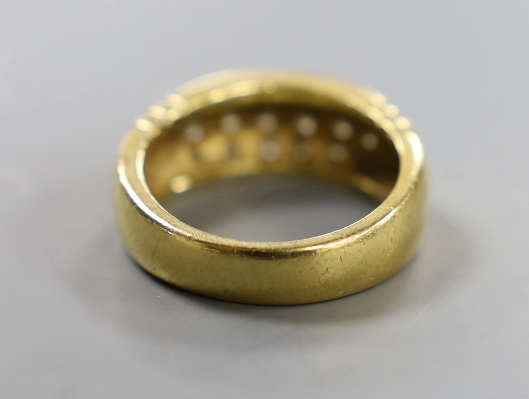 A yellow metal and eighteen stone pave set diamond ring, size Q/R